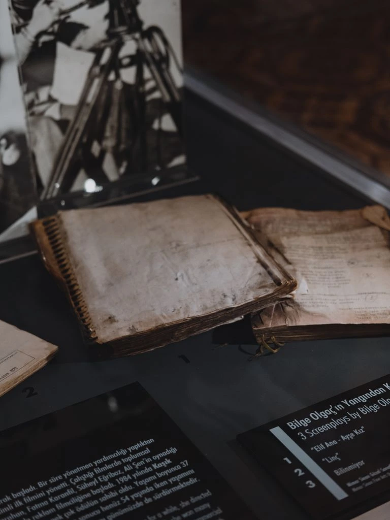 A notebook open on a pub table, beside a mug of coffee and a hand-drawn draft bracket.